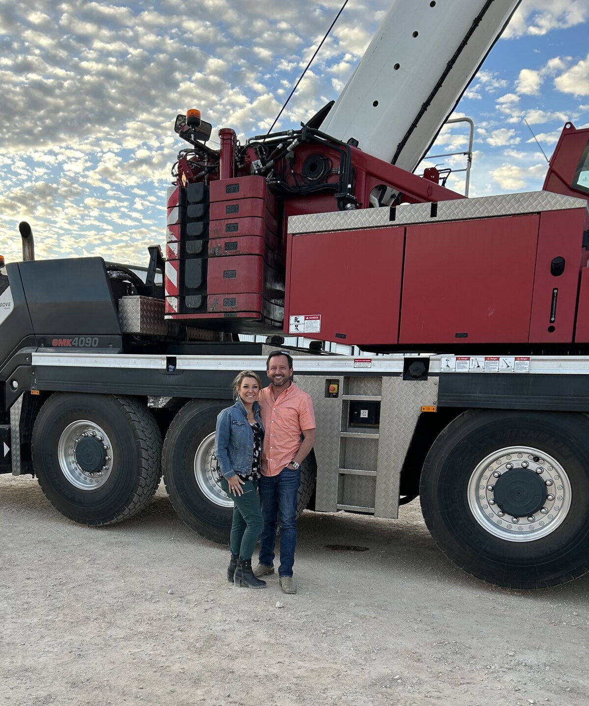 Katrina and Pete Smith, founders of Rhino Specialty Services, in their Odessa yard with their Grove GMK4090 all-terrain crane at sunset