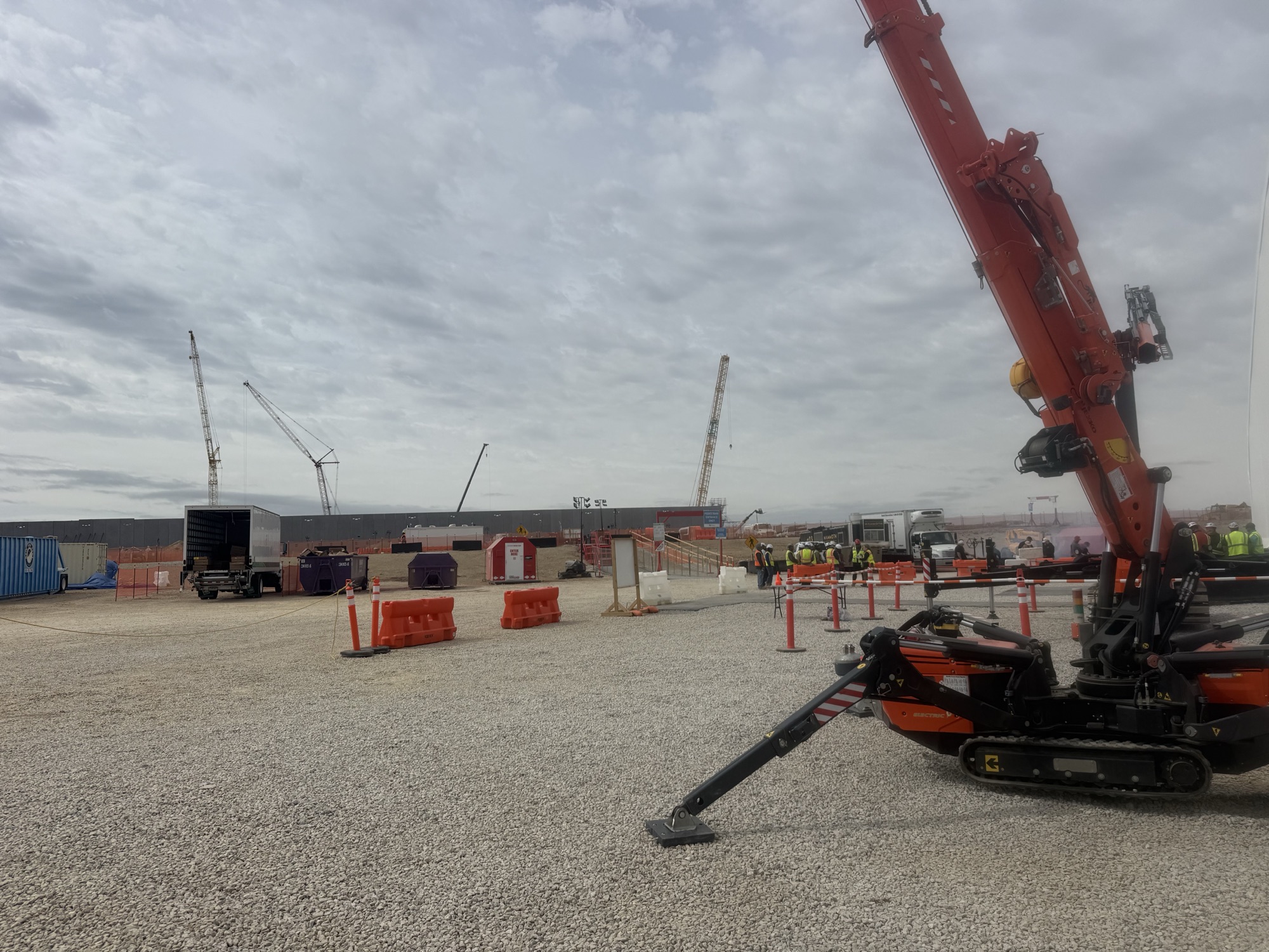Rhino's Jekko mini crane on an active data center build with lattice cranes in background
